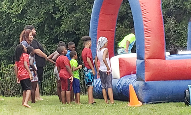 Children waiting in line for a bouncy house.