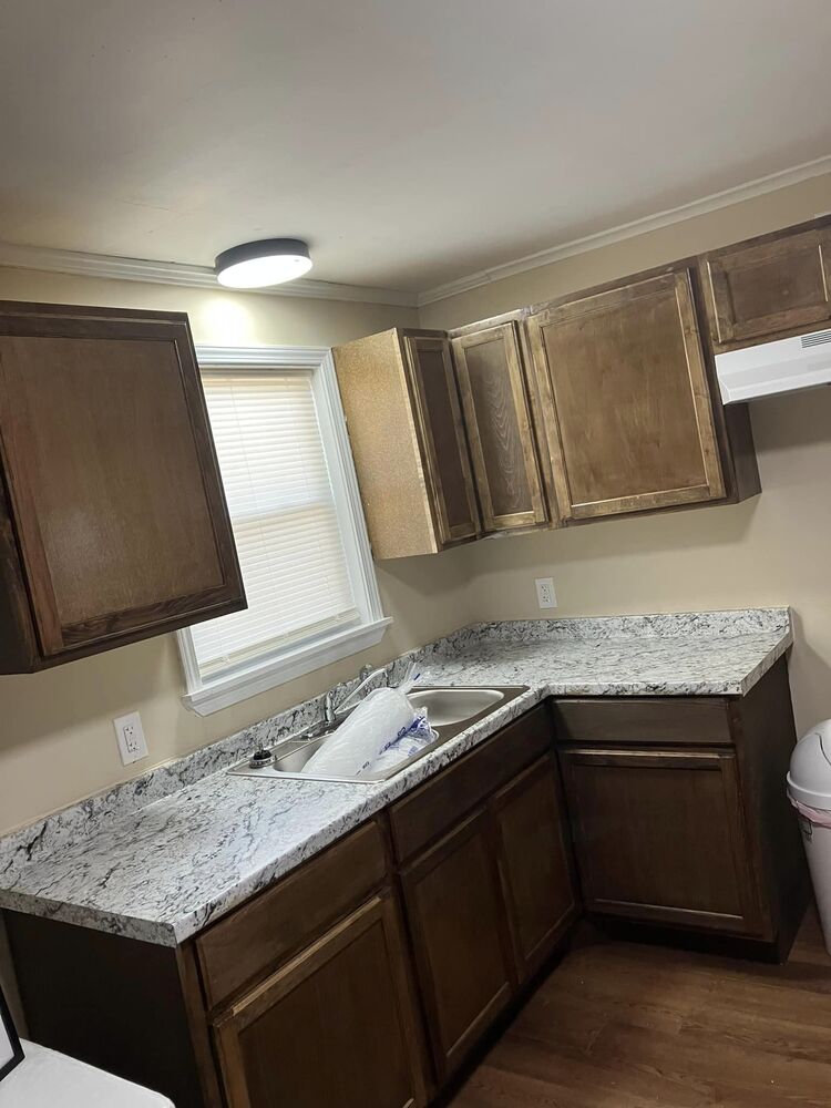 Kitchen cabinets, sink, and counters.