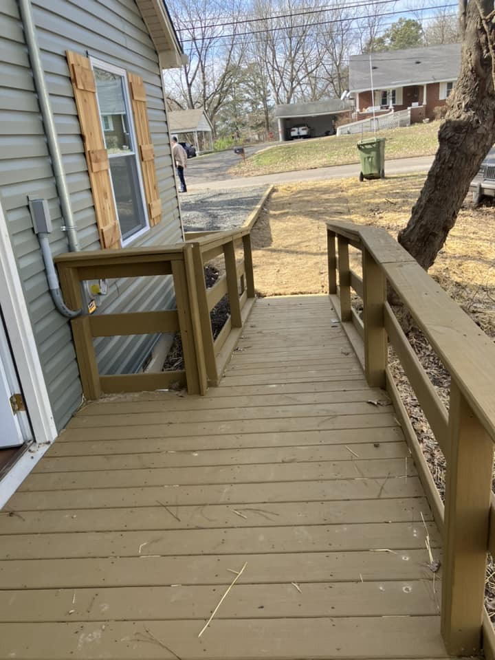 Deck on back of house with railings.