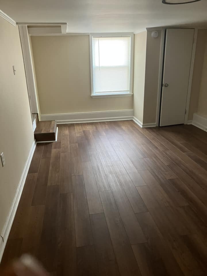 A room with a closet and a step leading out.