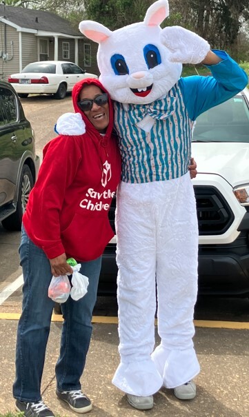 A picture of two people, one wearing an Easter bunny costume.