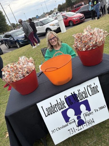 A lady sitting behind the Lauderdale Co. Medical Clinic table. 37 Cleveland Street. Ripley, TN 38063. 731.221.1804.