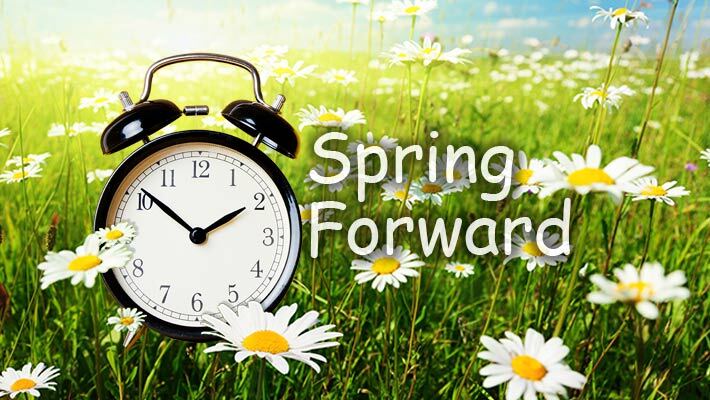Spring Forward. An alarm clock surrounded by daisies.