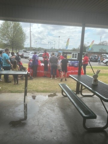People looking and talking to each other around presentation tables. 