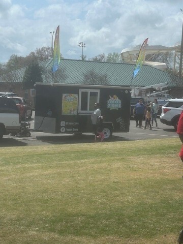 Food truck serving others in the street. 