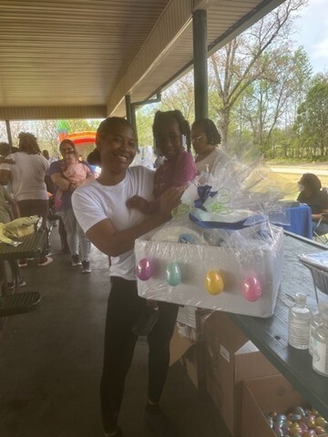 A woman holding a young girl smiling. 