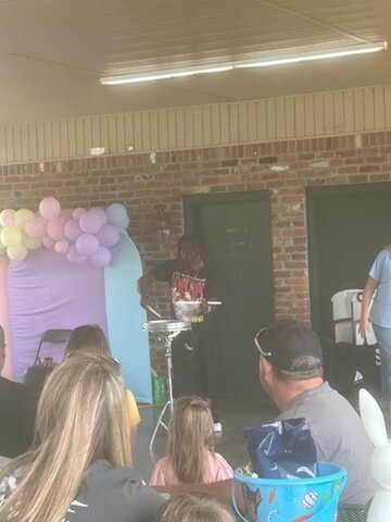 People watching a young man playing an instrument. 