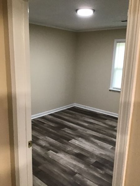 A room in 201 Volz with fresh paint, and new floors.